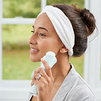 woman with beauty facial cleansing brush