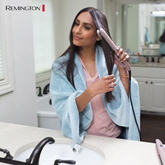 Woman doing her hair with Remington products.