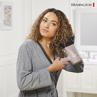 Woman using the Wet2Style blow dryer.