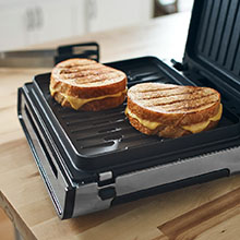 Two large grilled cheese sandwiches on the smokeless George Foreman grill.