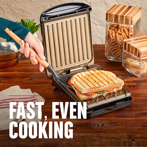 Fast, even cooking with the 2-Serving Classic Plate Electric Indoor Grill And Panini Press. Black with bronze plates - GRS040BZ