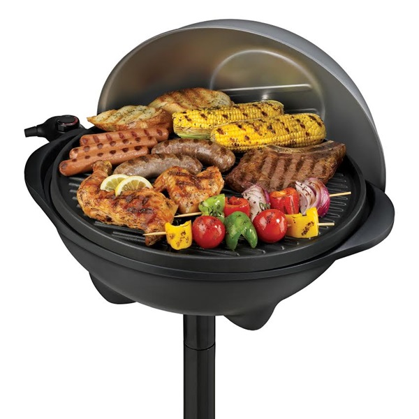 Open grill with food cooking on it.
